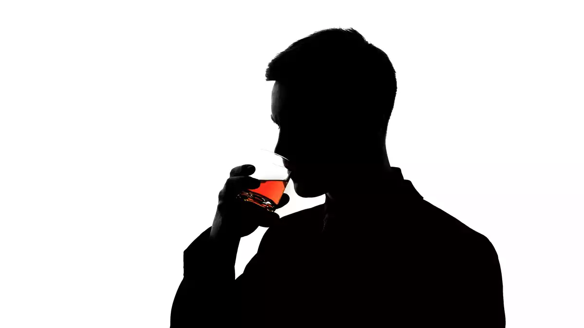A man's silhouette drinking